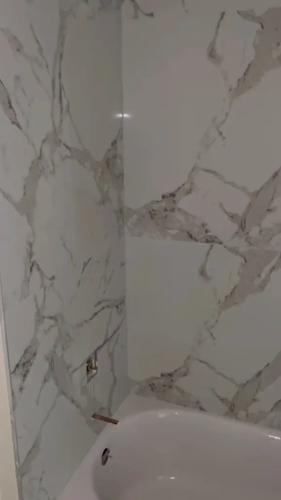 Tub walls tiled, ready for the faucet