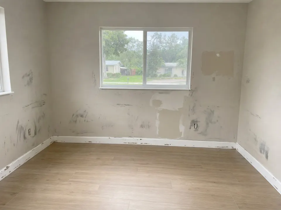 Worn, patched walls, before the repair
